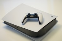 black and white ps5 console with game controller